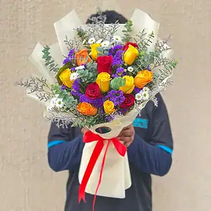A Vibrant Bouquet arranged with 12 Mixed Roses, Daisies, Statice or Sea Lavender and vibrant fillers.