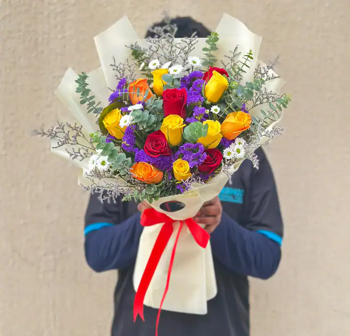 VibrantasYou A Vibrant Bouquet arranged with 12 Mixed Roses, Daisies, Statice or Sea Lavender and vibrant fillers.